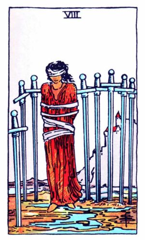 Eight of Swords tarot card, a blindfolded and bound figure surrounded by eight swords